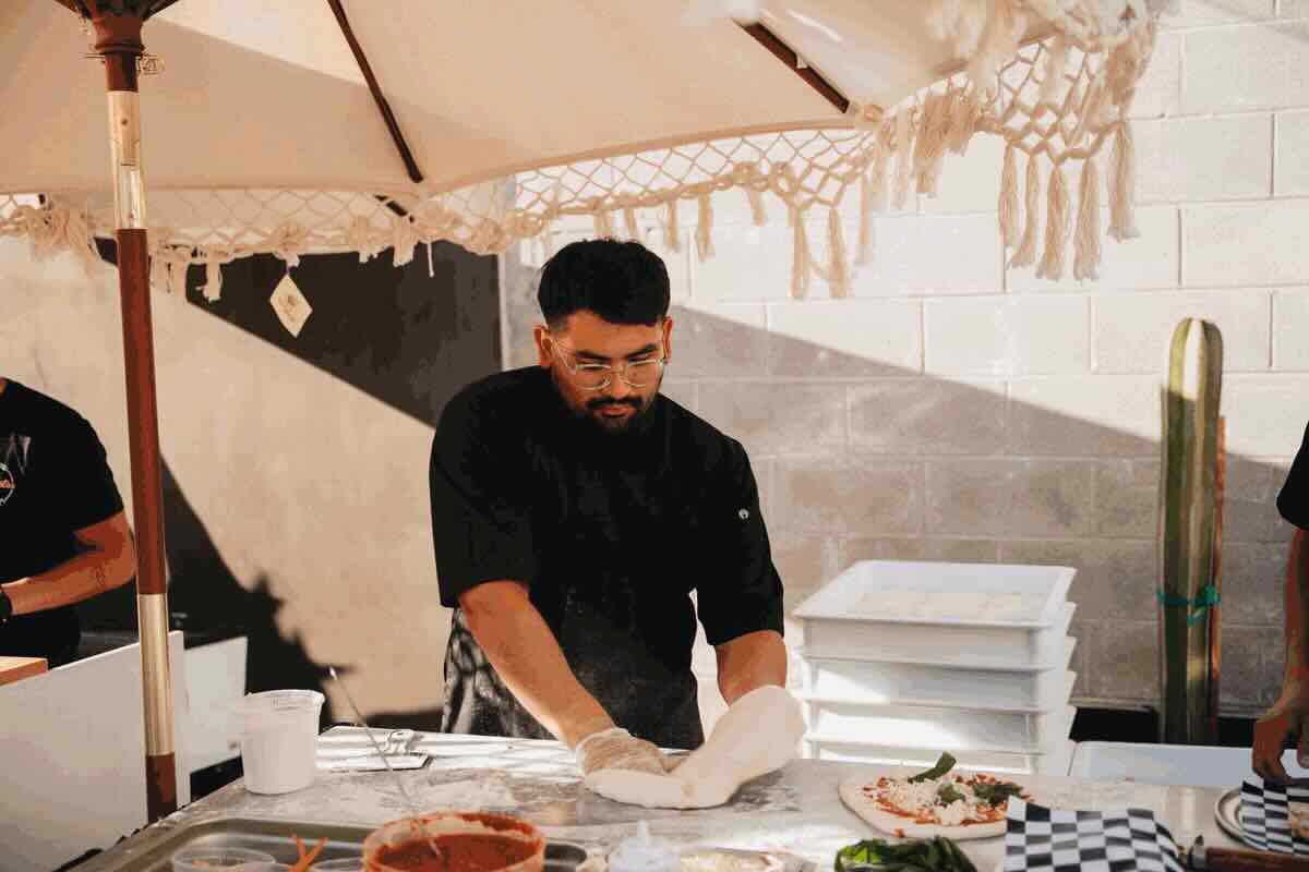 Private pizza chef preparing wood-fired pizza
